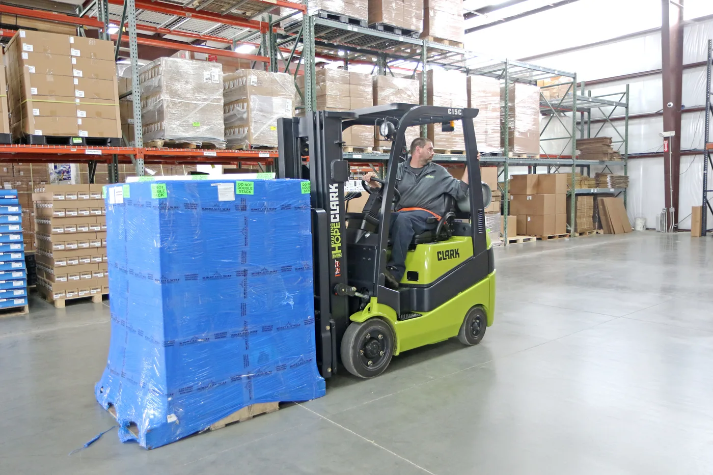 Clark forklift working in a warehouse aisle