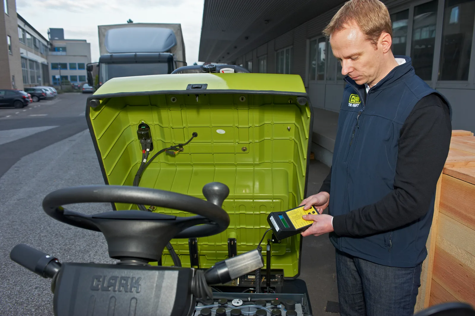 Technician servicing a Clark forklift