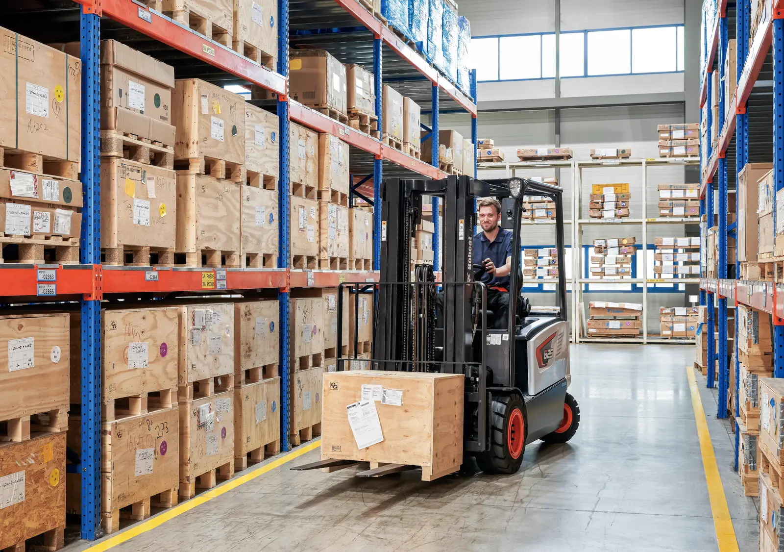Bobcat electric forklift working a distribution warehouse aisle