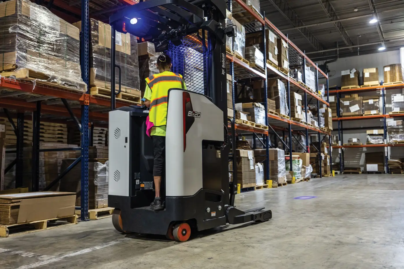 Bobcat reach truck placing a pallet at height