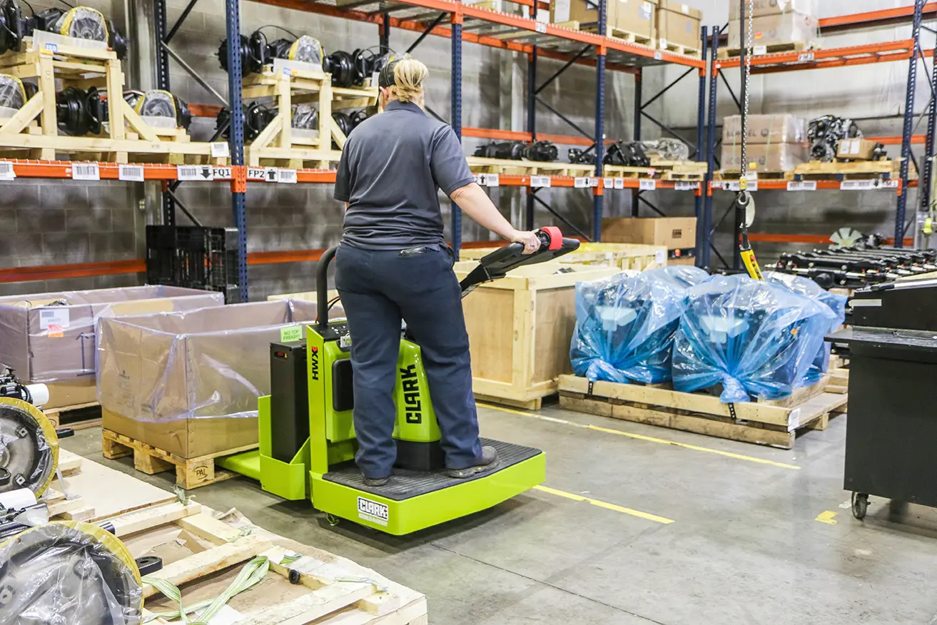 Clark HWX rider pallet truck moving parts in a plant