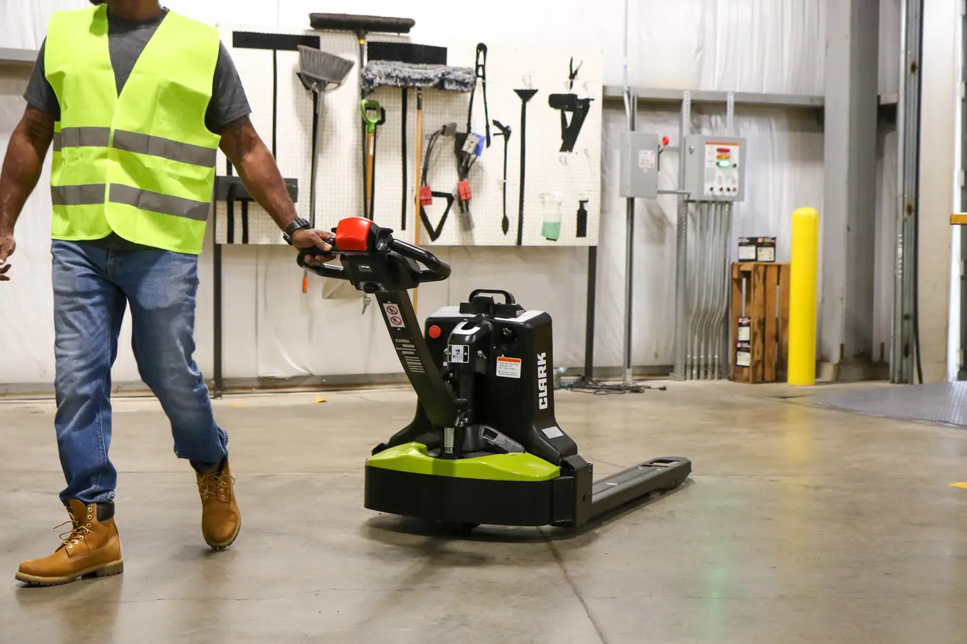Operator moving stock with a walkie stacker in a warehouse